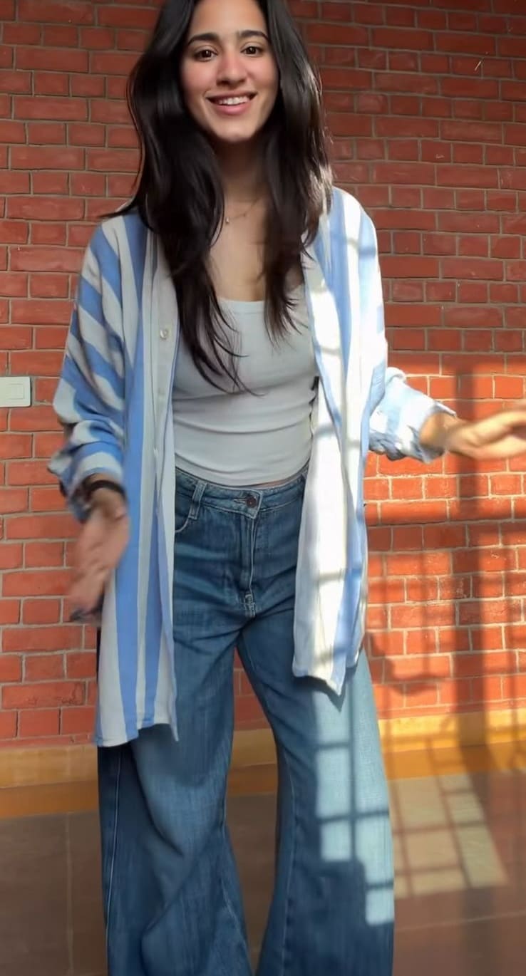 Oversized blue and white striped shirt over white tank with wide-leg jeans
