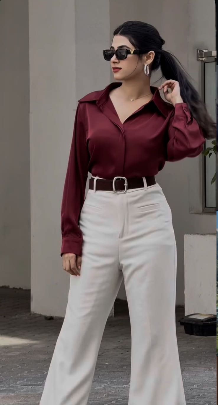 Maroon satin shirt with belted white wide-leg trousers and sunglasses