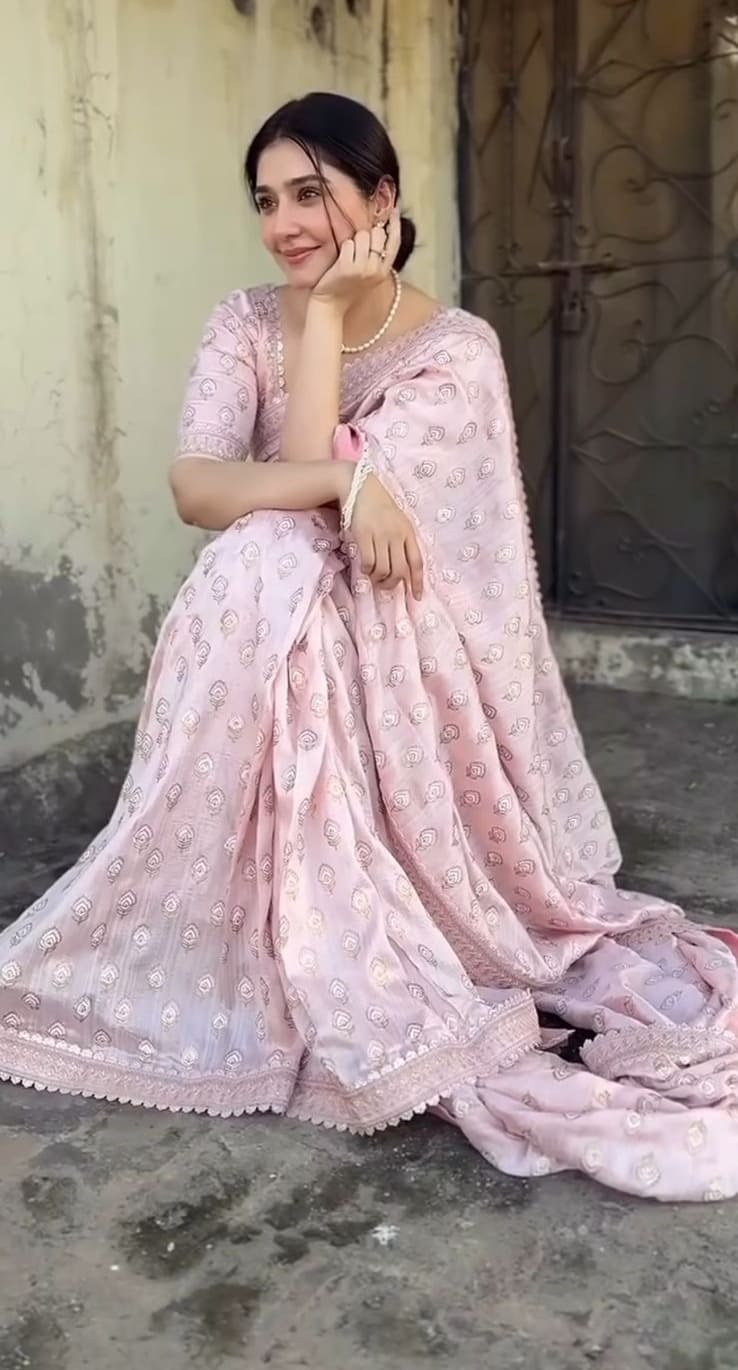 Pink printed saree with delicate floral motifs and pearl necklace